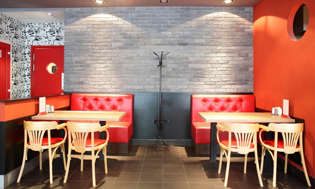 Red booth seating and tables in a venue