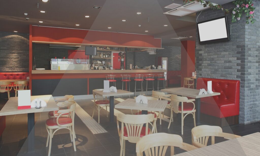 A room of tables facing a wall screen
