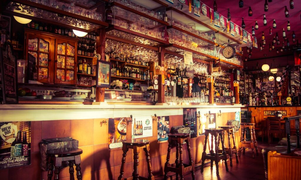 A traditional pub bar with bottles on display